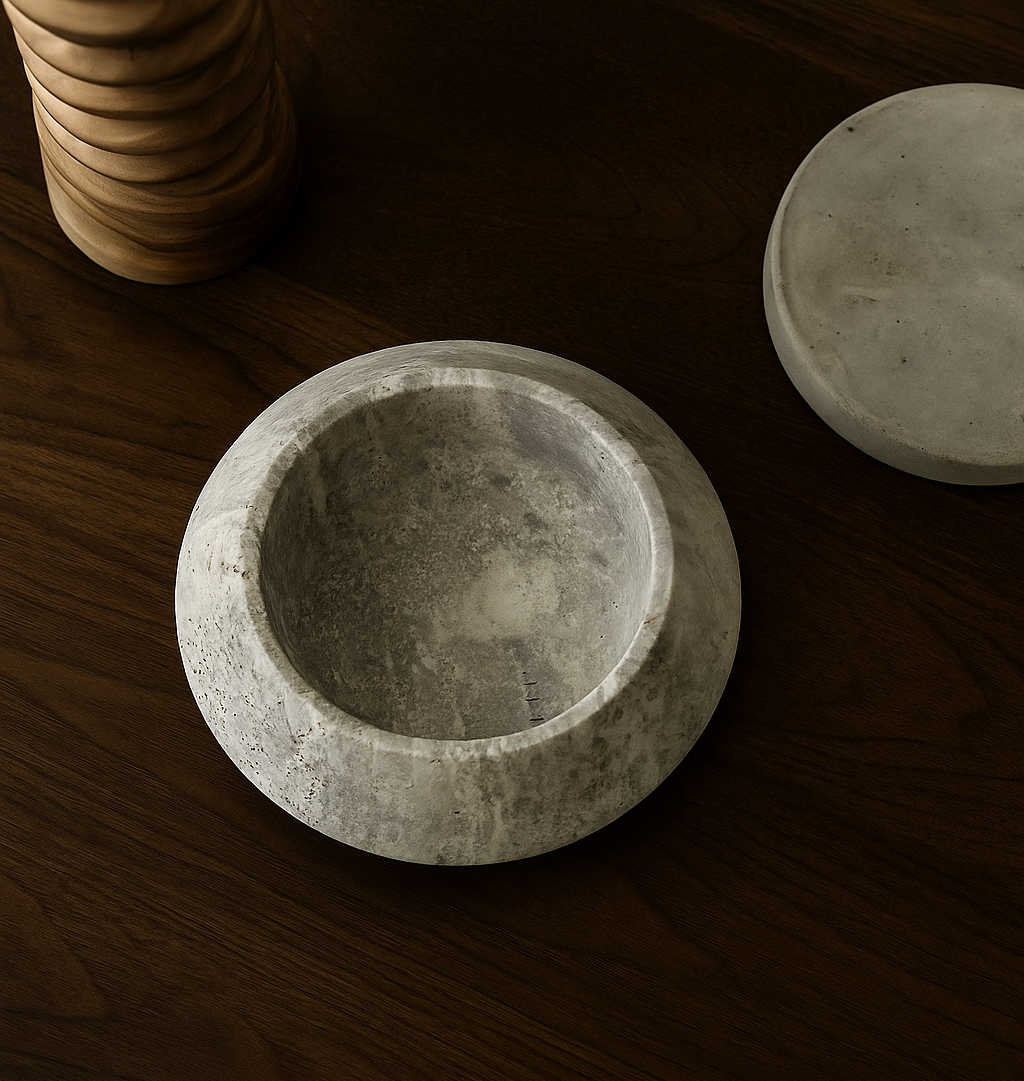gray travertine bowl on a wooden surface